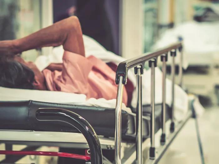 Emergency boarding patient in a hallway gurney