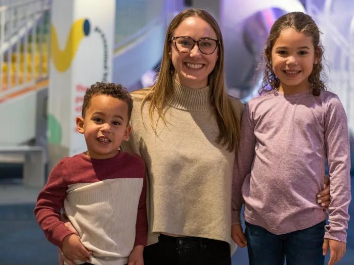 mom smiling with two kids