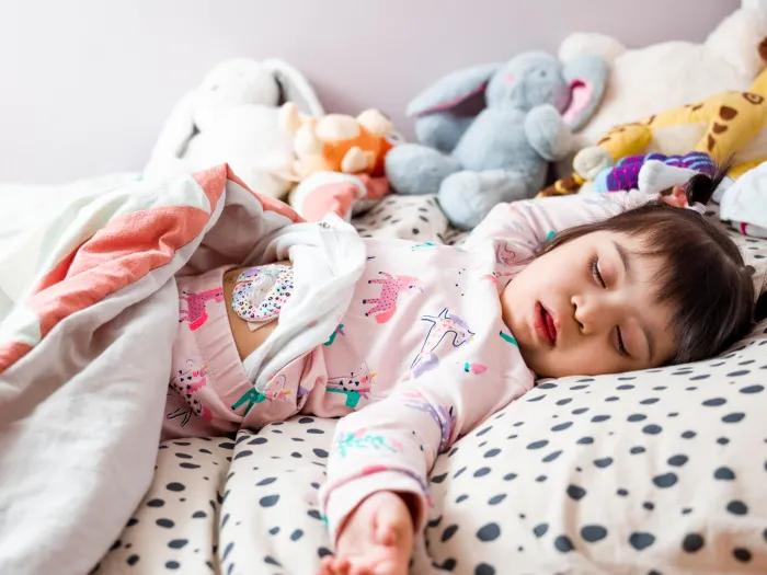 Girl with Down syndrome sleeping in bed