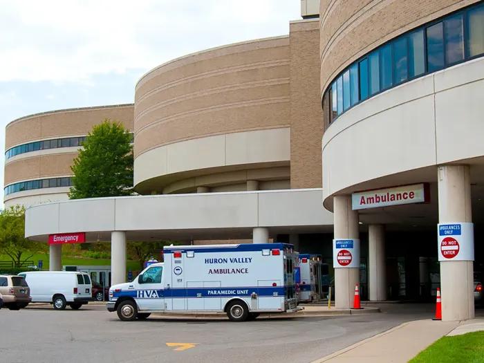 Entrance to Adult Emergency Services with an ambulance parked out front.