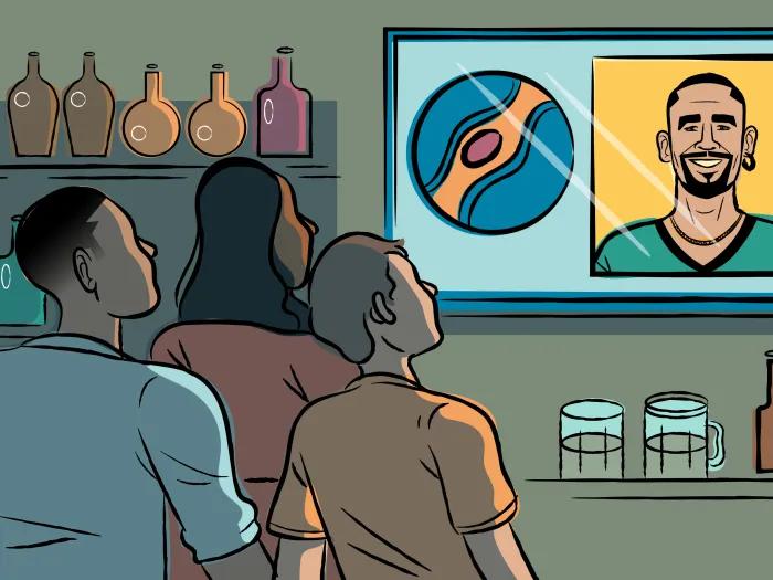 Three people in a bar watch a television displaying a sports logo and a person smiling. Shelves with bottles and a counter with glasses are visible.
