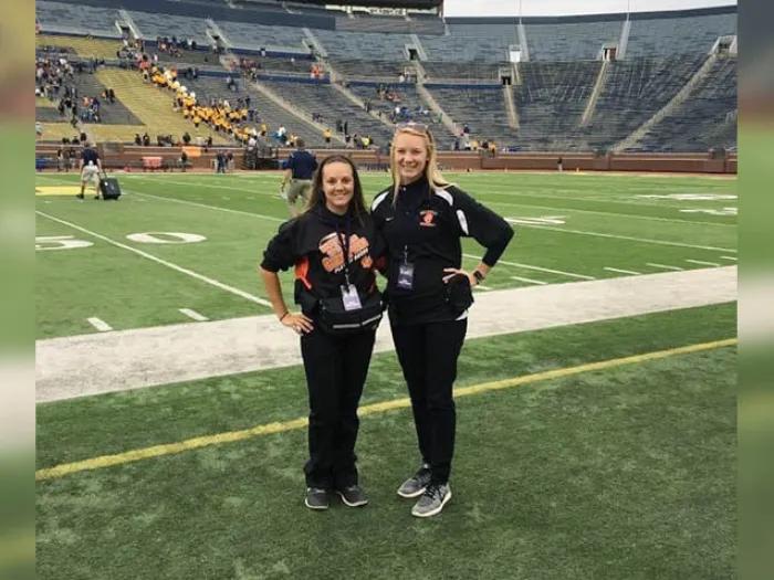 two females on the field at michigan big house
