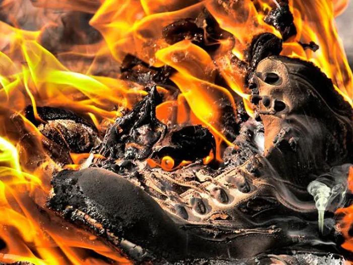 army boot burning fire smoke