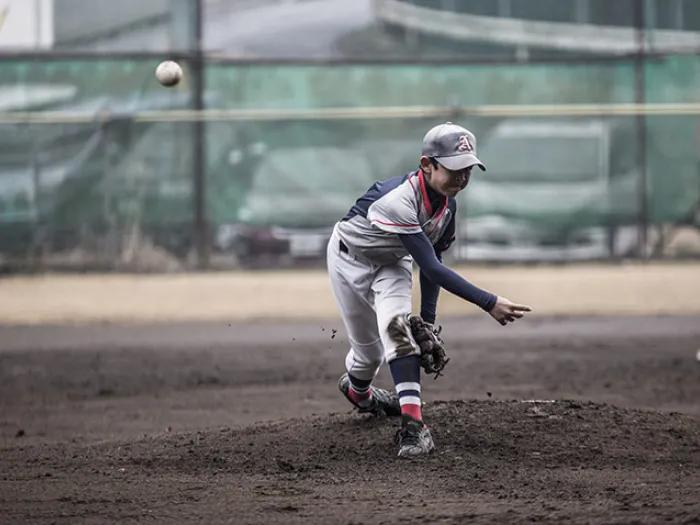 Boy pitching ball 
