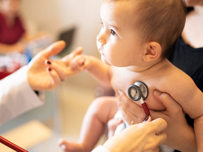 baby with stethoscope on heart