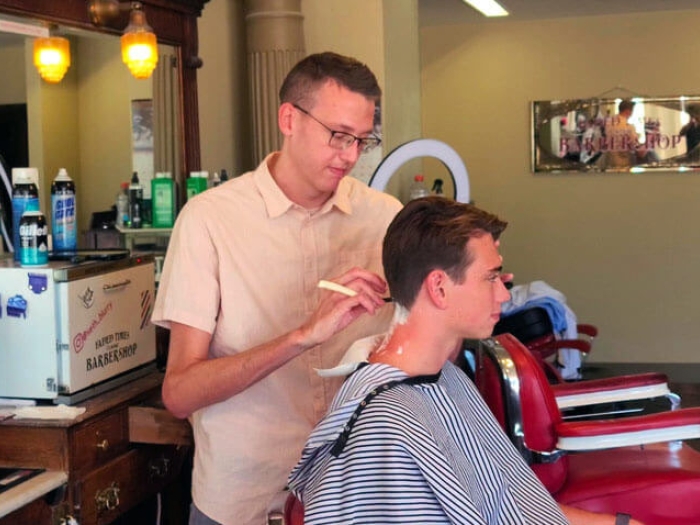 Barber cutting boys hair