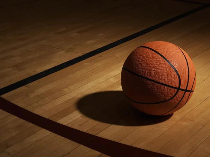 orange basketball shadow on court floor line