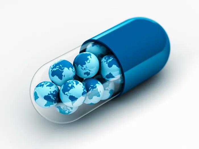 blue pill with globes inside of it piled up