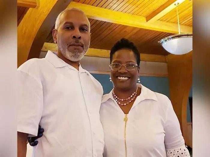 husband and wife smiling wearing white shirts