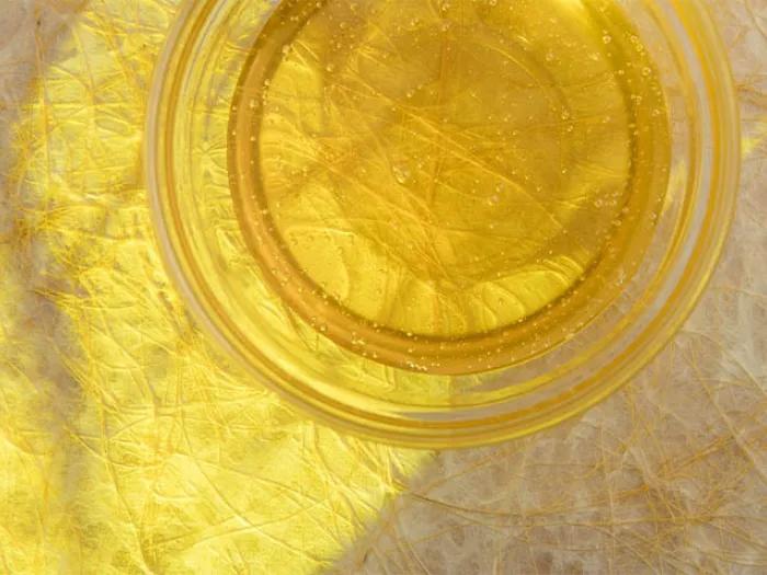 cup of honey on decorative beige surface