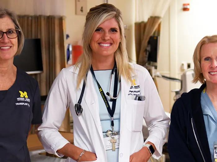 Doctor and nurses smiling in clinic room at hospital