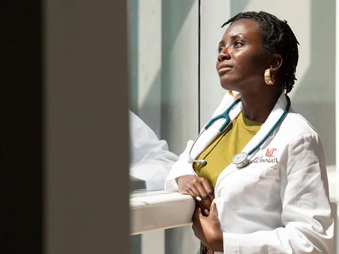 doctor smiling window hallway sunlight