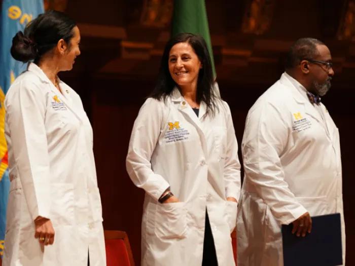 doctors in white coats standing next to each other