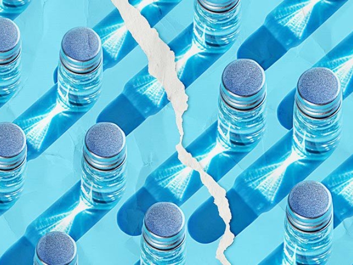 blue background with glass vials with torn paper in between 
