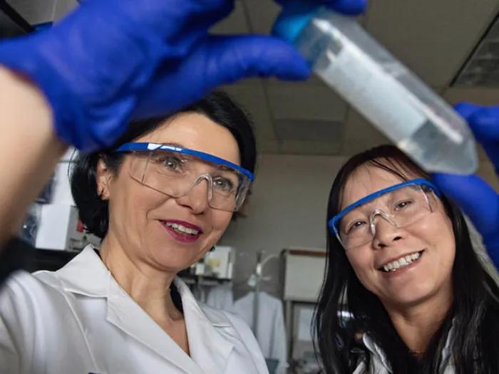 Researchers looking at vial