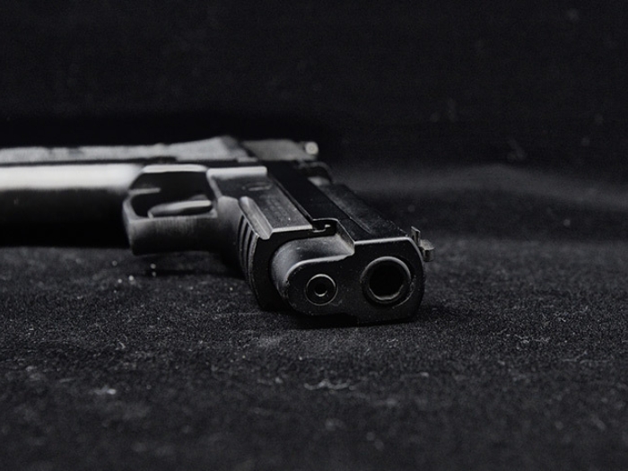 dark gun pistol on ground in dark room 