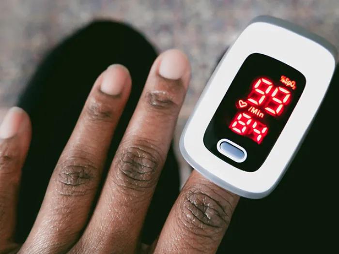 hand and fingers with pulse device oxygen on it 