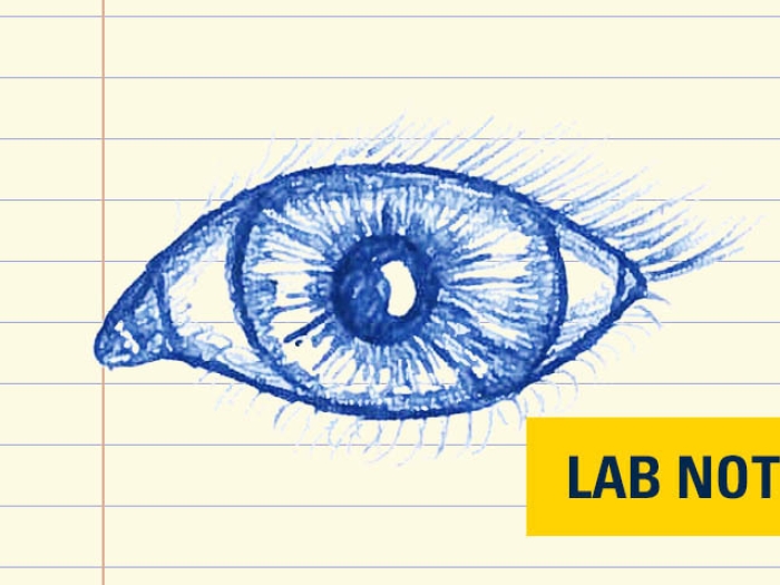 blue ink drawing of an eye on lined notepad paper with yellow badge saying lab note
