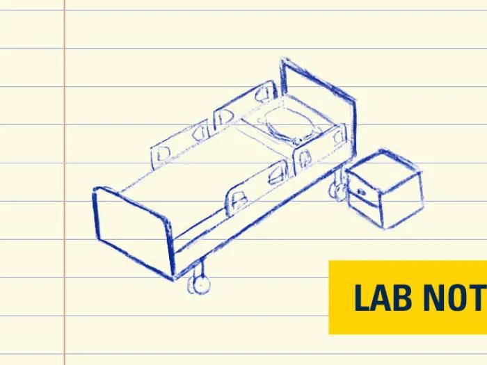 hospital bed drawing in blue ink on lined paper with yellow  badge bottom right saying lab note in blue font