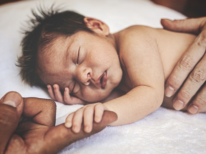 newborn baby sleeping hands blanket