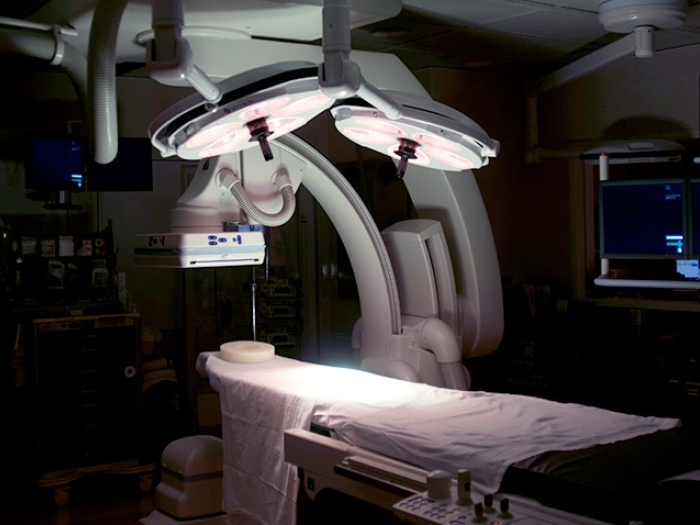 operating room in dark room with dramatic lights over operating table
