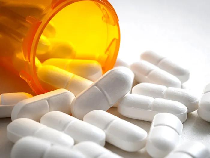 pills spilling out orange bottle