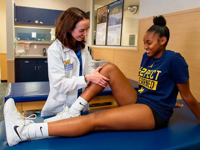 Provider doing leg stretching exercises on athlete