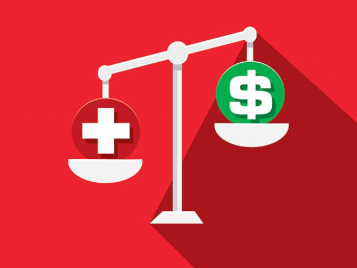 Scales healthcare money on a weigh scale with red background