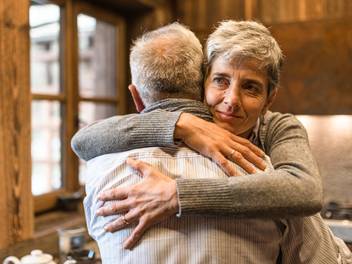 Senior couple hugging in kitchen