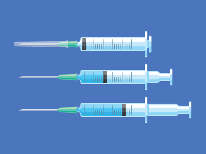 Three syringe needles with vaccines on blue background