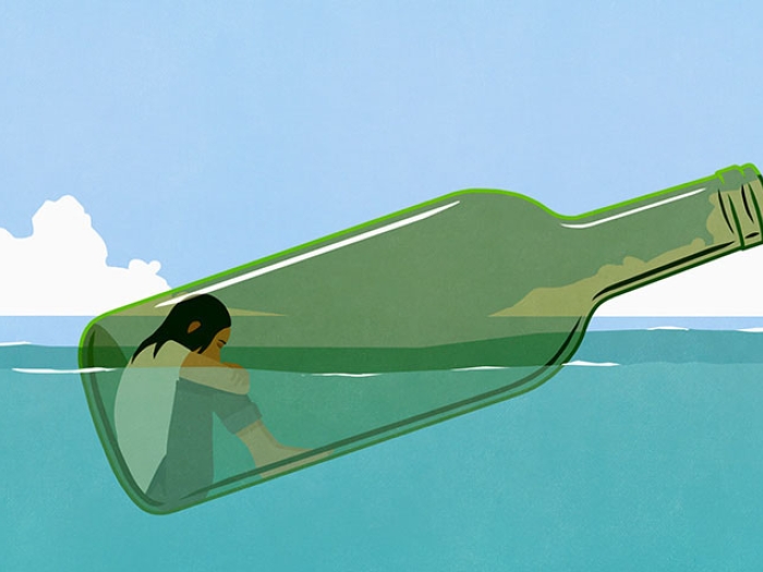 Woman floating in wine bottle in ocean