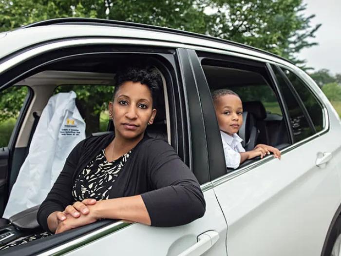 Doctor in white car with child looking out the window