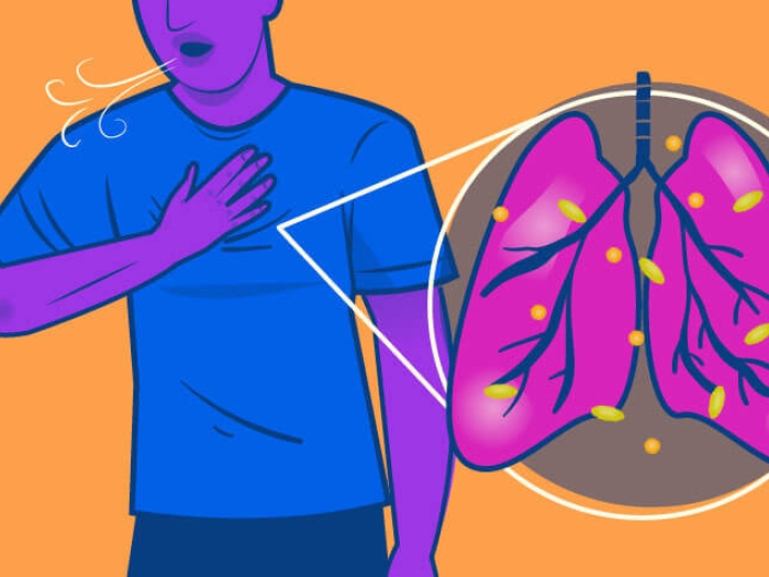Person in blue shirt touching chest, orange background, pink lung image