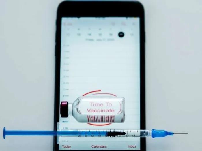 cell phone with vaccine bottle