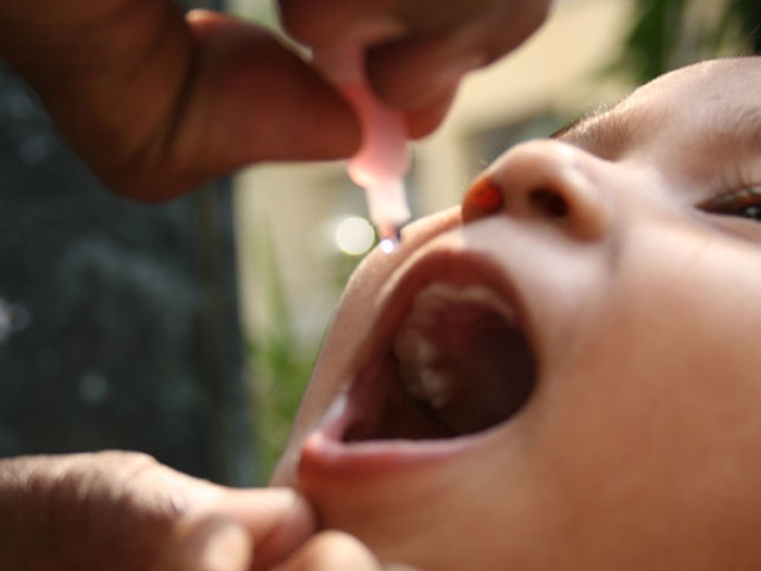 child receiving polio vaccine drops