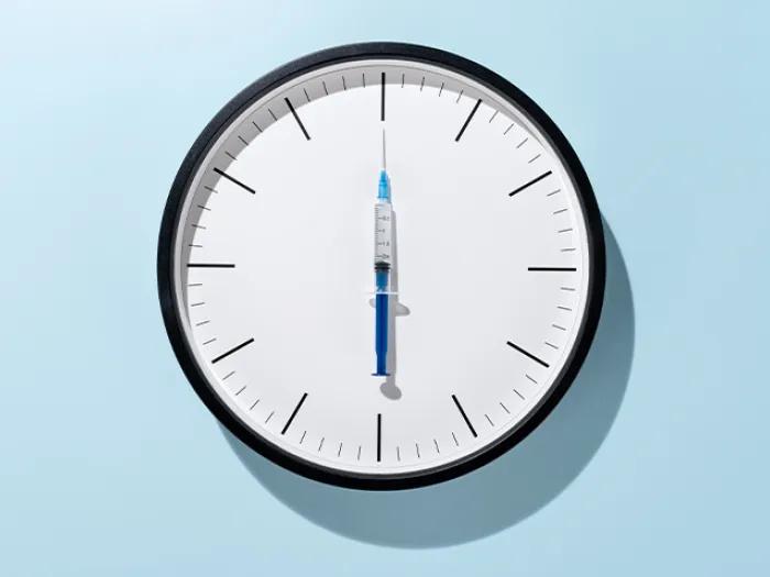 clock with vaccine as clock hand