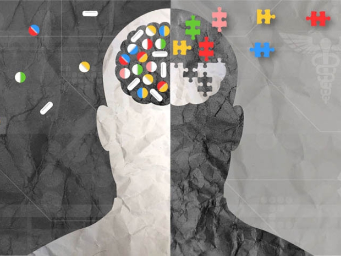 grey outline of a brain with the left side light grey and the right side dark grey and colorful puzzle pieces floating in and out of the brain