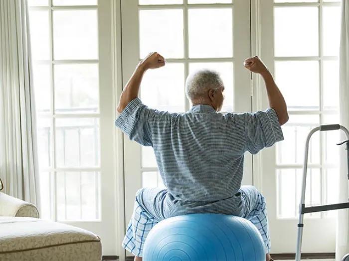 Elderly man working out at home