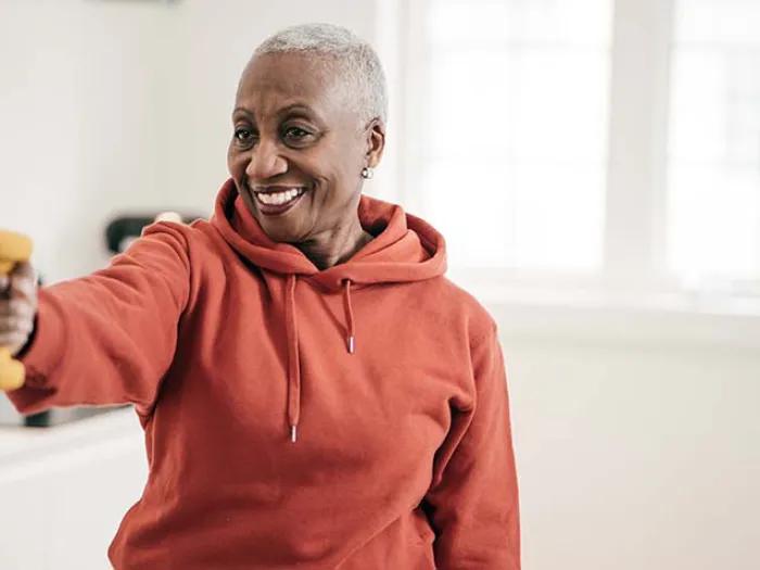 Elderly women exercise with hand weights