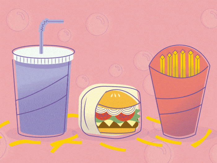 Fast food convenience, fries, drink, hamburger on pink background with Covid virus floating around