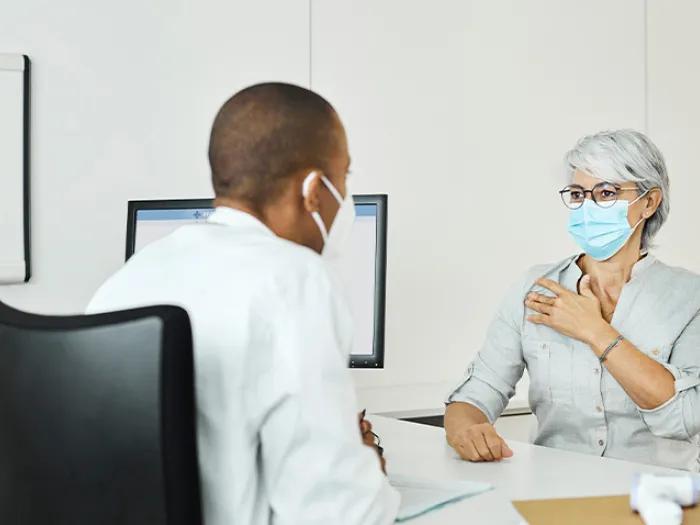 female patient discussing with doctor