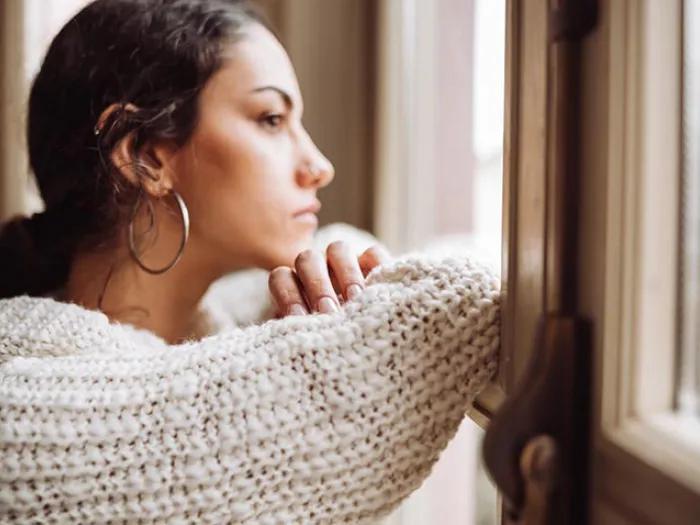 Female looking out window