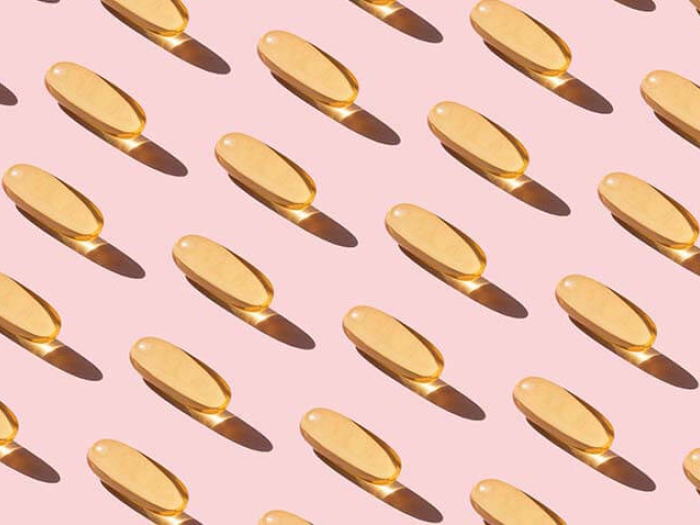 Fish oil pills on pink background