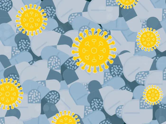 grey pills background with COVID-19 yellow cells popping out on top