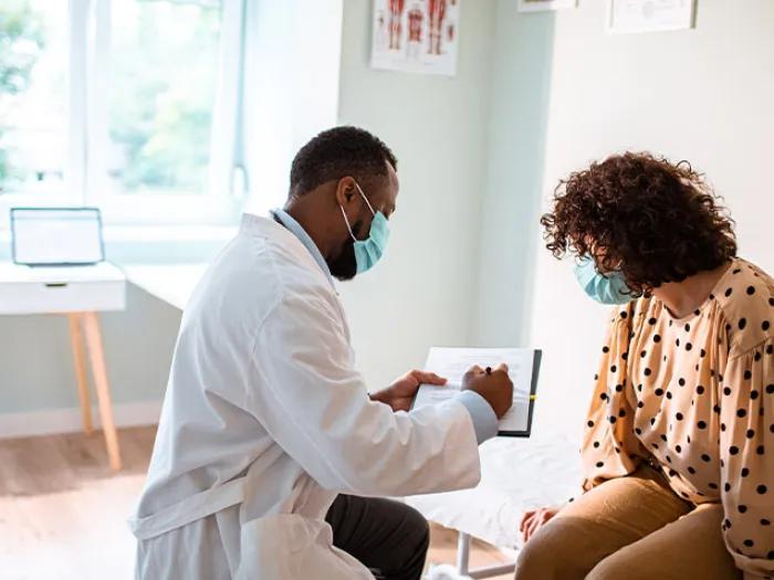 male doctor showing woman info