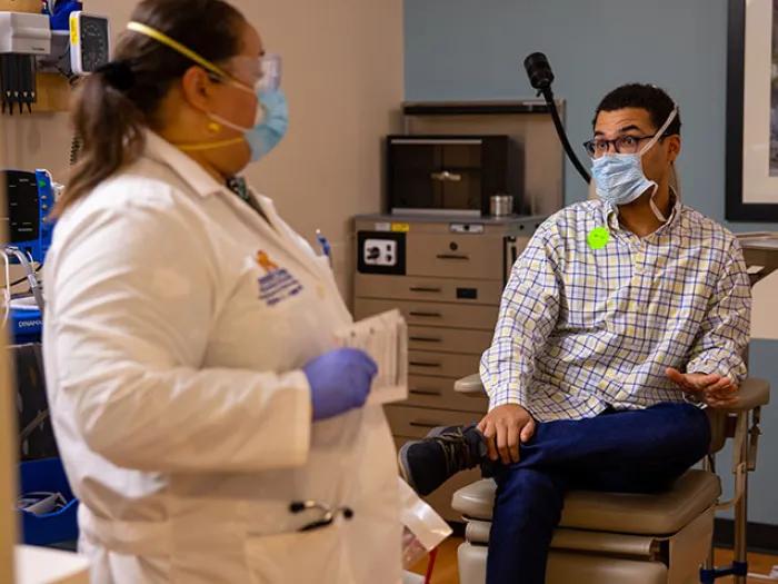man talking with doctor in office