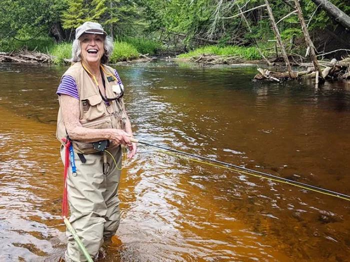 Carol fly fishing on the Maple River.