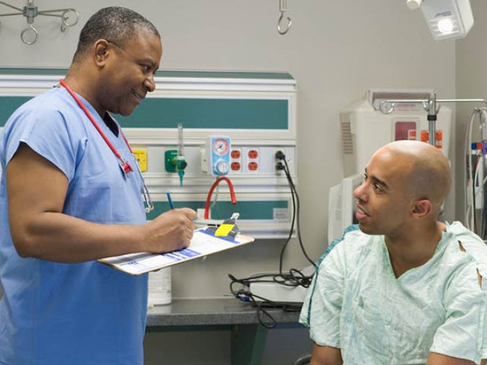 patient talking to physician in doctor&#039;s office