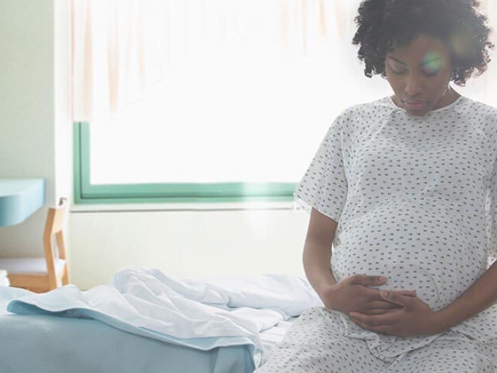 Pregnant women in hospital gown in a hospital room