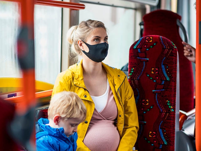 pregnant woman on bus with child
